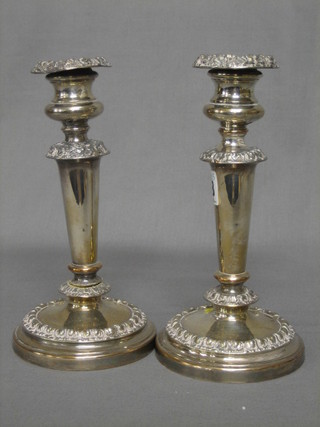 A pair of silver plated candlesticks 8"