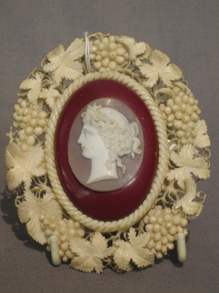 A Victorian oval carved cameo of Diana, contained in a pierced ivory frame 4"