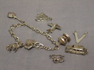 A silver curb link charm bracelet hung 4 charms with heart shaped padlock clasp and 4 other loose charms