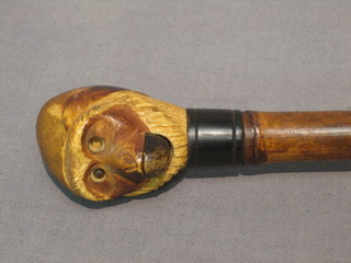 A humerous and unusual Edwardian parasol, the carved ivory handle in the form of a monkey with stone set eyes