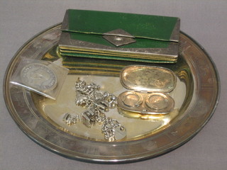 A circular silver plated dish, a green leather wallet with silver mounts, a silver sovereign case (f) and a curb link charm bracelet