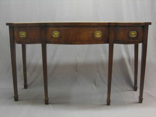 A Georgian mahogany bow front serving table/sideboard fitted 1 long drawer flanked by a pair of 2 short drawers, raised on square tapering supports ending in spade feet (timber let in both sides of top) 62"