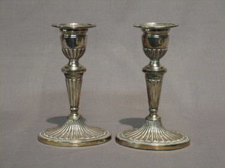 A pair of silver plated candlesticks with reeded decoration  6 1/2"