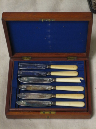 12 silver plated fish knives contained in a walnut canteen