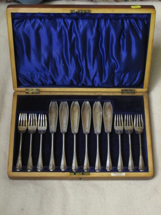 A set of 6 silver plated fish knives and forks in a walnut canteen box