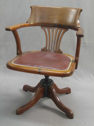 An Edwardian mahogany pierced splat back revolving office chair 