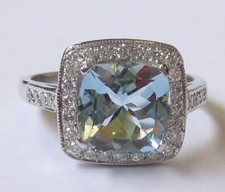 A lady's 18ct white gold dress ring set a square cut aquamarine supported by diamonds (approx 0.39/2.62ct)