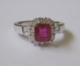 An 18ct white gold dress ring set a square cut ruby surrounded by diamonds (approx 0.86ct/1.39)