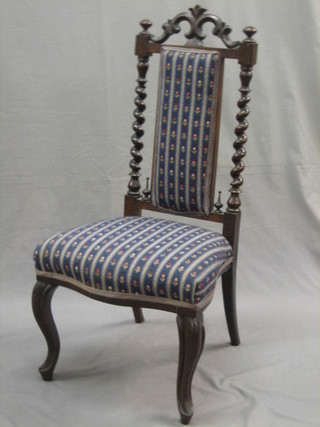 A Victorian mahogany nursing chair upholstered in striped material