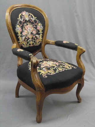 A Victorian Continental walnut open arm chair, raised on cabriole supports