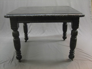 A Victorian ebonised oak extending dining table, raised on turned supports with 1 extra leaf 41"