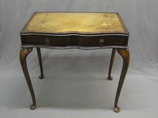 A Queen Anne style walnut side table of serpentine outline with inset writing surface fitted 1 long drawer, raised on cabriole supports 30"