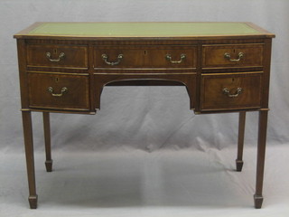 A 19th Century bow front mahogany writing table with inset tooled green writing surface fitted 1 long and 4 short drawers, raised on square tapering supports ending in spade feet 41"