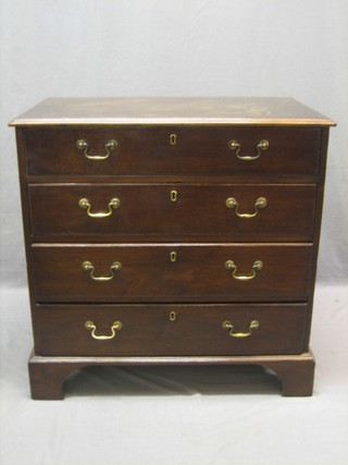 A Georgian mahogany chest of 4 long drawers with brass swan neck drop handles and escutcheons, raised on bracket feet