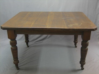 A Victorian oak extending dining table with 1 extra leaf 51", raised on turned supports