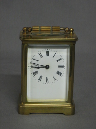 A 19th Century French 8 day carriage clock with enamelled dial and Arabic numerals contained in a gilt metal case