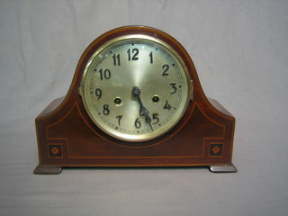 A 1930's striking mantel clock with silvered dial contained in an arch shaped inlaid mahogany case