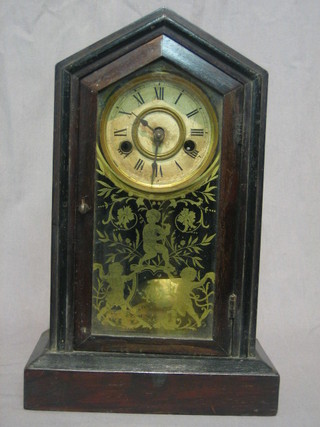 An American 8 day striking mantel clock with paper dial contained in a mahogany case 8"