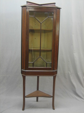 An Edwardian inlaid mahogany corner cabinet, the top with gallery, the interior fitted adjustable shelves enclosed by astragal glazed panelled doors, raised on square supports 22"