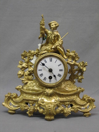 A 19th Century French mantel clock with enamelled dial contained in a gilt painted spelter case surmounted by a figure of a huntsman