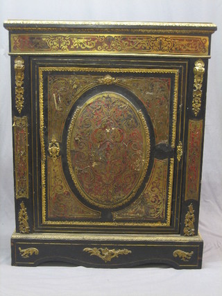 A 19th Century ebonised and red boulle cabinet, enclosed by a panelled door, with gilt metal embellishments throughout, raised on a platform base 36" (requires some attention)