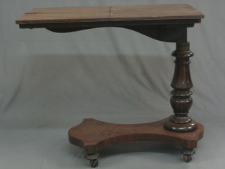 A 19th Century adjustable pedestal reading table of rectangular form with a ratcheted slope 32"
