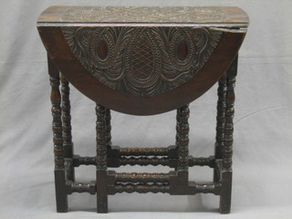 An 18th/19th Century carved oak oval drop flap tea table raised on turned and block supports 26"