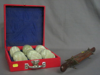 An Indian carving knife and fork contained in a hardwood case together with 6 onyx goblets contained in a red plush case