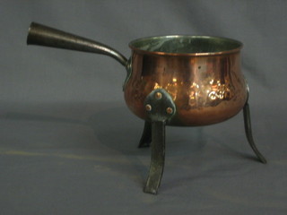 An Art Nouveau style planished copper saucepan with polished steel handle, raised on 3 legs 5"