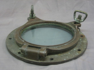 A circular brass port hole complete with glass 15 1/2"