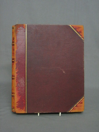 A Victorian leather bound photograph album containing various black and white photographs
