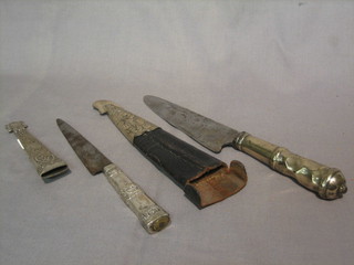An Eastern dagger with 6" blade marked M Bertad? contained in a leather scabbard with silver mounts and 1 other Eastern dagger with 5" blade complete with silver scabbard, scabbard marked Risso Y Daneri