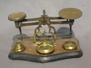 A pair of brass letter scales and 6 weights