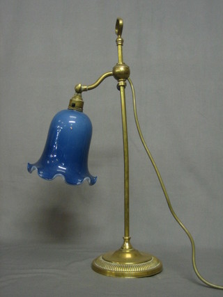 A 19th Century brass adjustable reading lamp with green glass shade