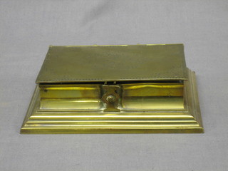 A 19th Century brass travelling writing set in the form of a  book fitted an inkwell, stamp box and taper stick 7"