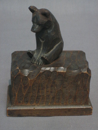 A Bavarian carved wooden wall mounting match box holder? surmounted by a figure of a bear 