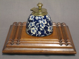 A Victorian Prunus pattern porcelain dome shaped inkwell with gilt metal mounts, raised on an oak base 7"