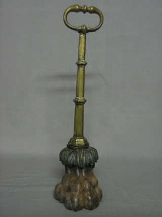 A Victorian iron and brass door stop in the form of a clawed foot