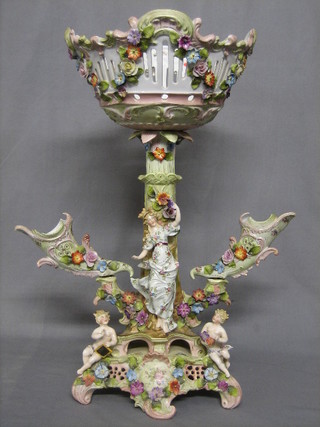 A handsome 19th Century German porcelain table centre piece comprising a pierced bowl supported by a column and lady and having 2 cornucopia shaped vases to the side, 21" (some chips throughout)