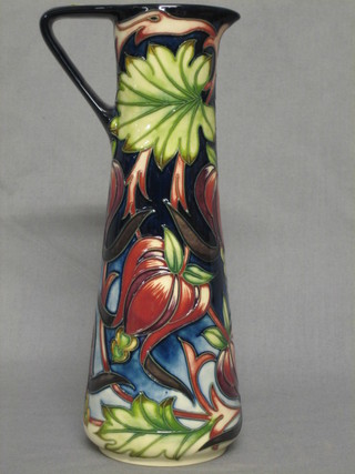 A  Moorcroft Red Ribbons jug designed by Shirley Hayes, made for the Moorcroft Collectors Club in 2004, with purple, orange and red floral decoration, limited edition no. 245, the base signed and impressed, 9"