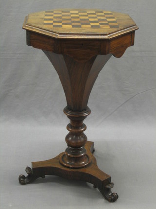 A Victorian rosewood games/work table of conical form with hinged lid inlaid a chessboard, raised on a triform base with scrolled feet 17"