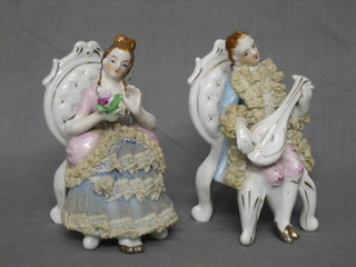 A pair of Continental porcelain figures of seated Crinoline lady and gentleman 5"
