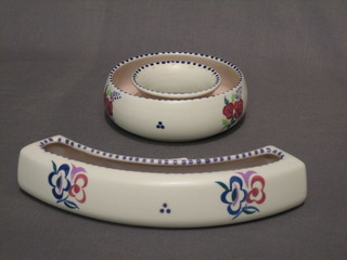 A Poole Pottery crescent shaped flower holder 8" and a flower ring 5"
