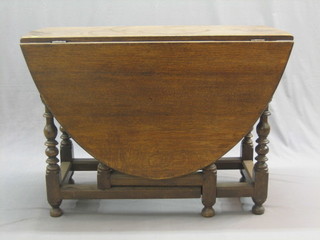 A 20th Century, 17th Century style carved oak oval drop flap gateleg dining table, raised on turned and block supports 42"