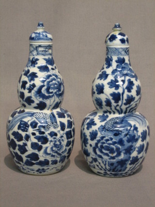 A pair of 19th Century Oriental double gourd shaped blue and white vases, the base with 4 character signature 7"