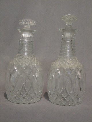 A pair of 19th Century cut glass ring neck decanters with non matching stoppers (some chips to rims) 9"