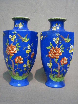 A pair of Edwardian octagonal blue glazed pottery vases decorated birds amidst flowering branches 12"