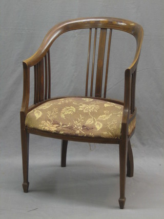 An Edwardian inlaid mahogany tub back chair raised on square supports