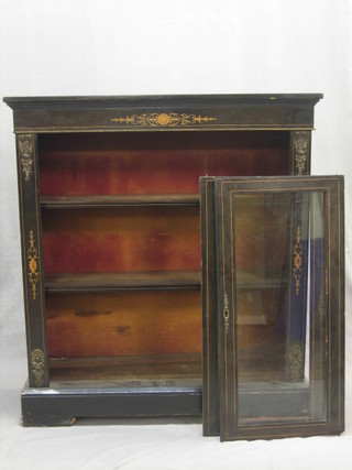 An ebonised Pier cabinet with gilt metal mounts enclosed by a pair of panelled doors, raised on a platform base 36"