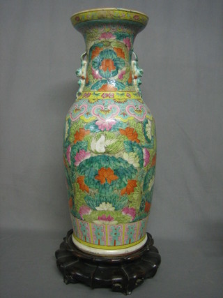A 19th Century Canton famille vert porcelain vase with dragon handles, raised on a hardwood stand 23" (cracked)